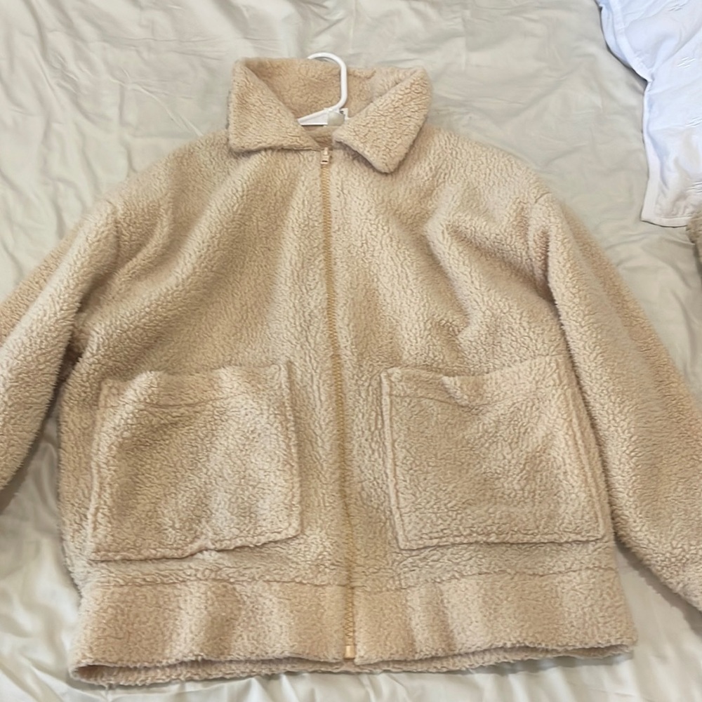 this creme fuzzy zip up is from pink and a size small